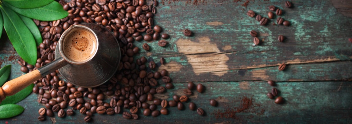 Freshly roasted coffee beans and a cup of coffee at MOKKA